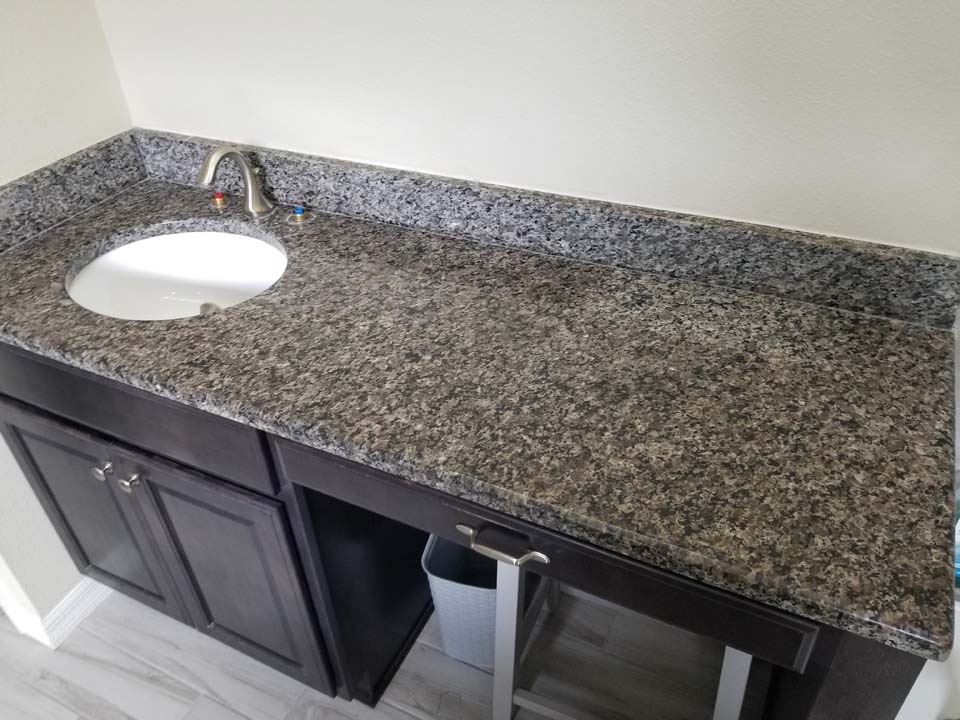 20230123_113330 This shows a bathroom vanity with stains in the granite